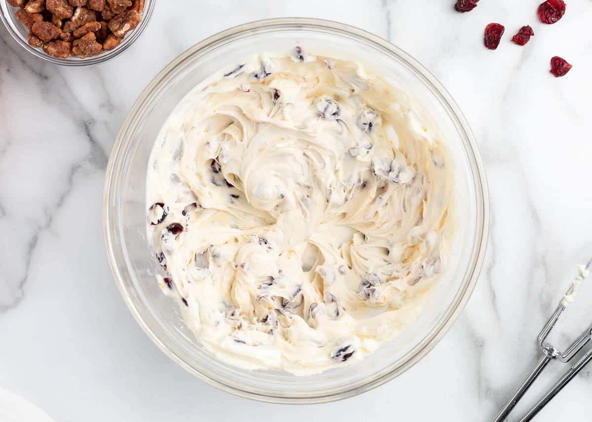 mixed cream cheese and cranberries in bowl