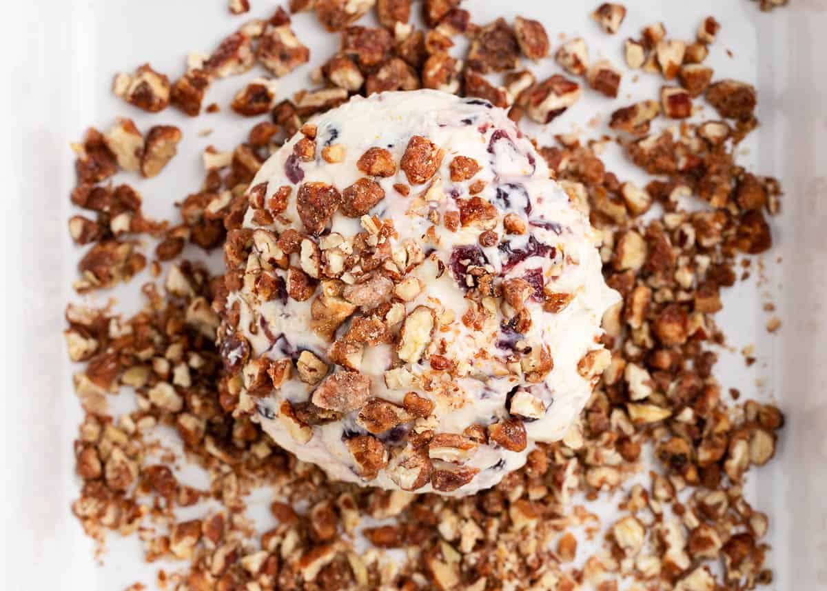 rolling cheese ball in pecans