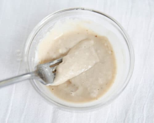 whisking flour and broth in bowl