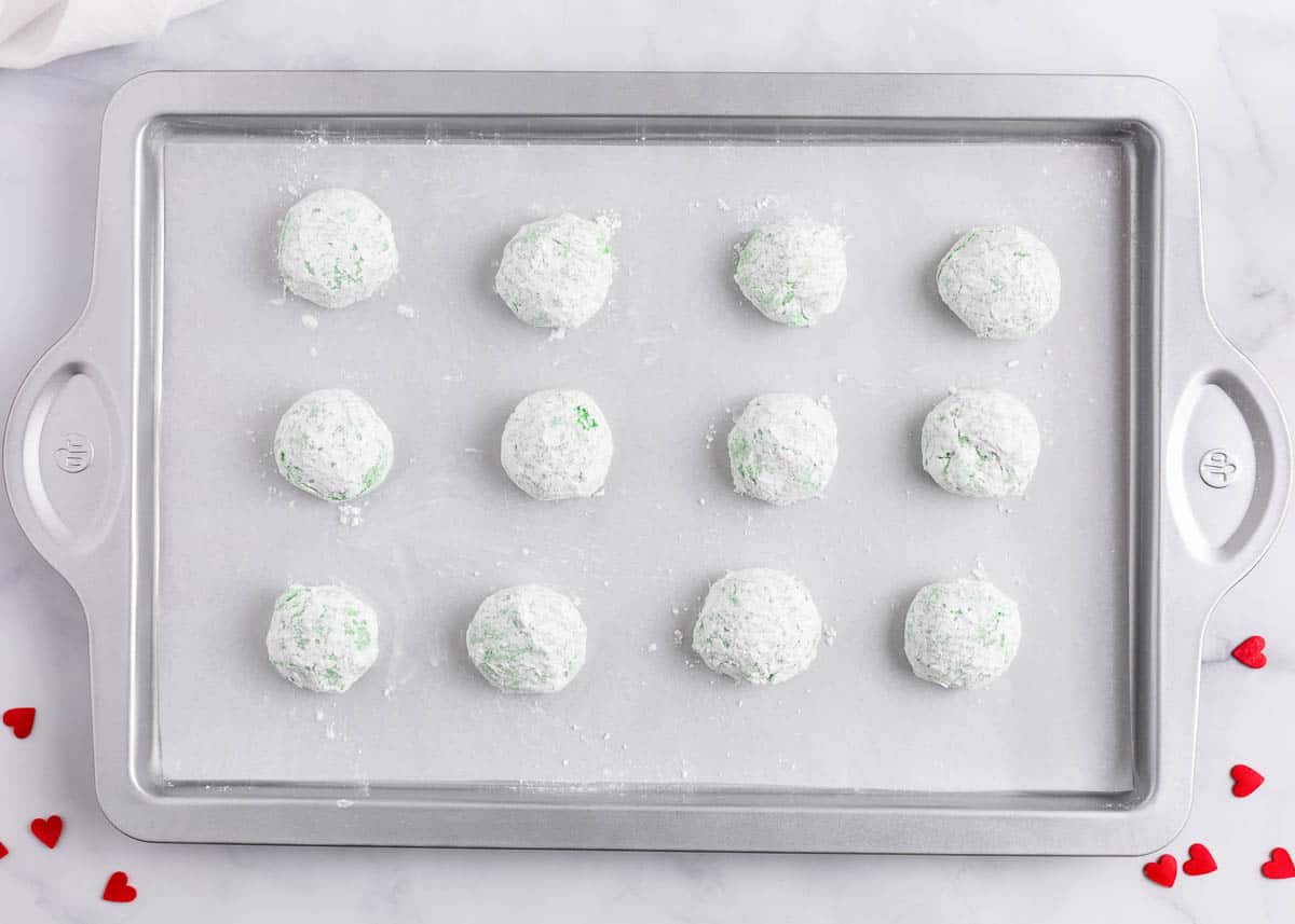 powder sugar cookie dough balls on pan