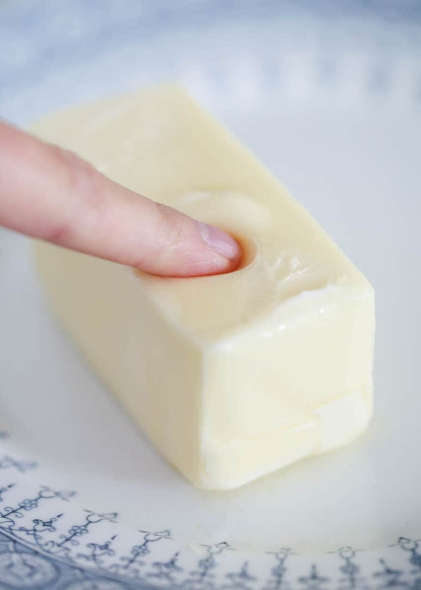 pressing finger into softened butter