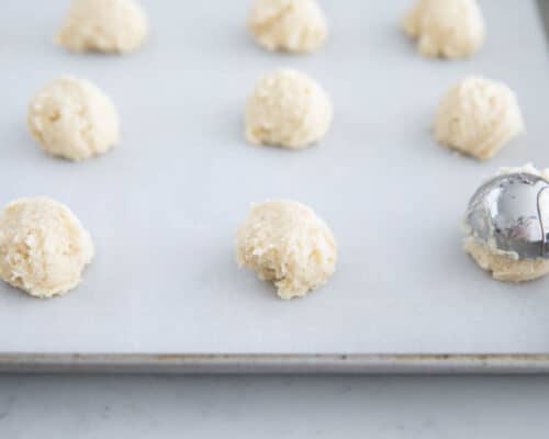 cookie dough balls on baking sheet