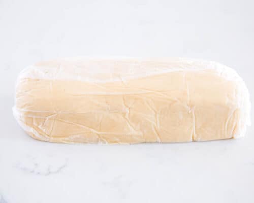 shortbread dough log wrapped in plastic
