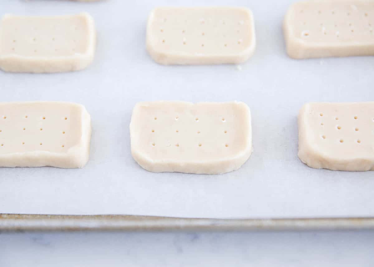 These shortbread cookies are so easy to make with only 5 ingredients, melt in your mouth, and turn out beautiful every time. They are perfect to make cut out, pressed or stamped shortbread cookies. shortbread cookies on pan