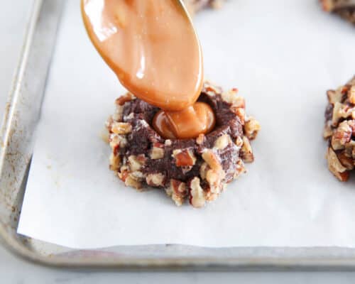 pouring caramel onto cookie