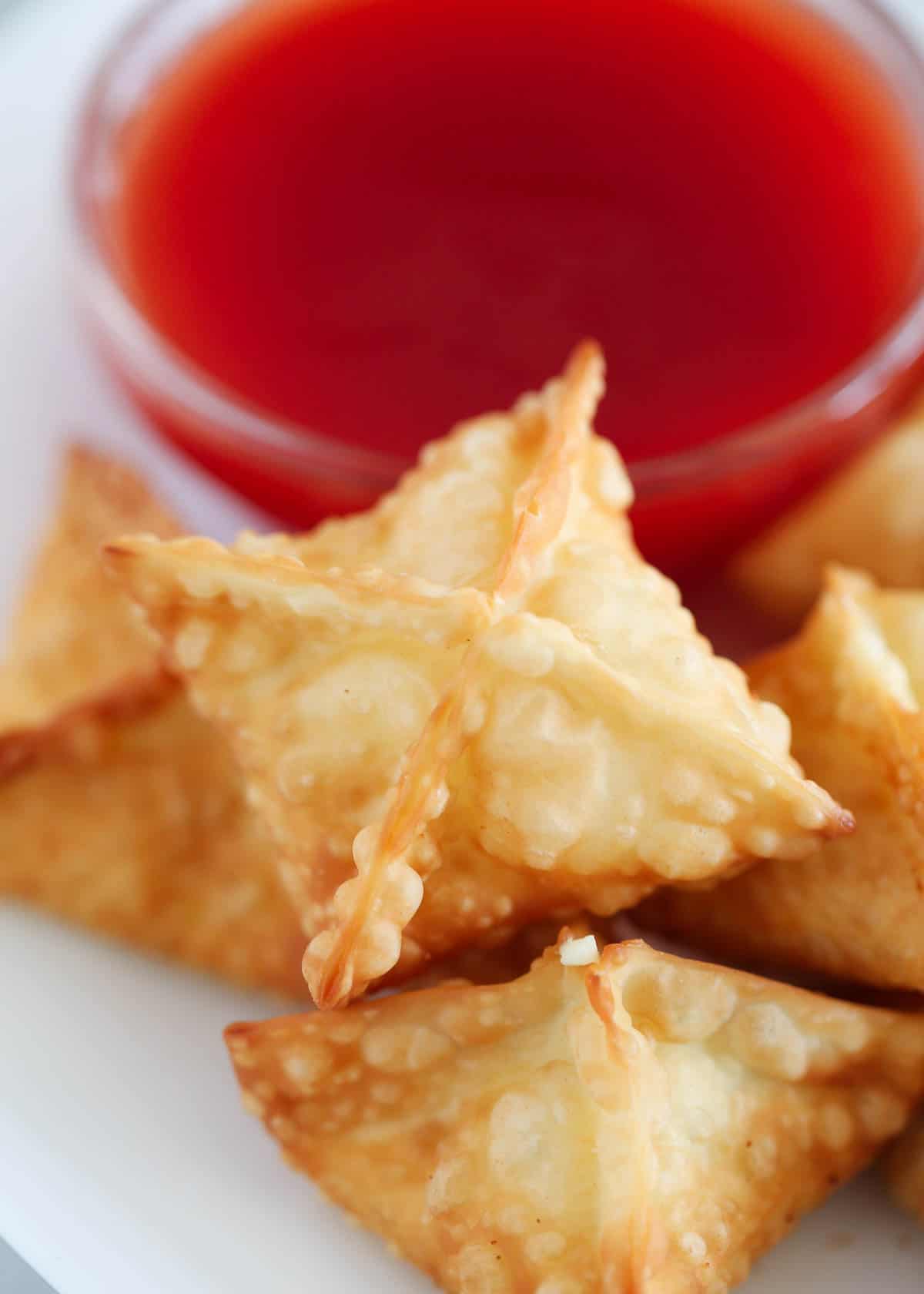 Cream cheese wontons on a plate.