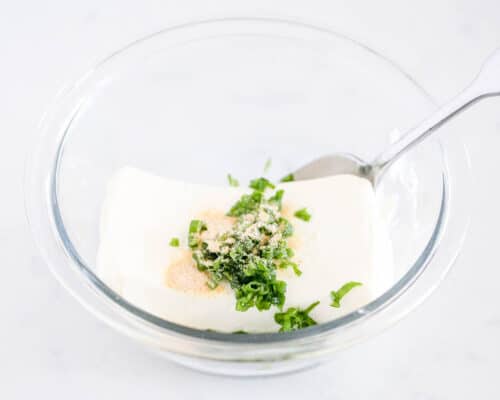 cream cheese and green onions on bowl