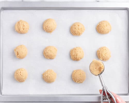 scooping cookie dough on pan
