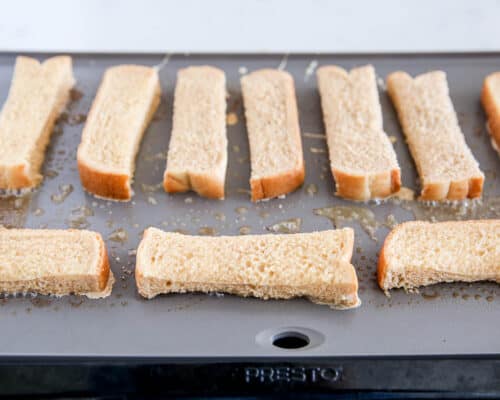 french toast sticks cooking on pan