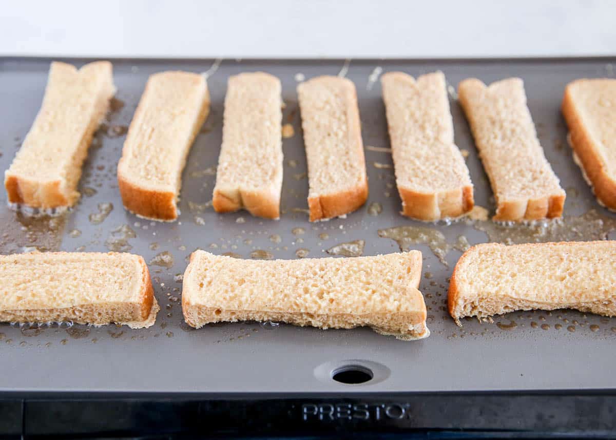 french toast sticks cooking on pan