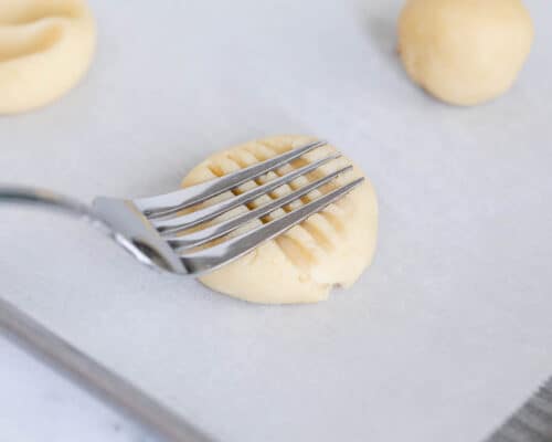 pressing fork into cookie dough