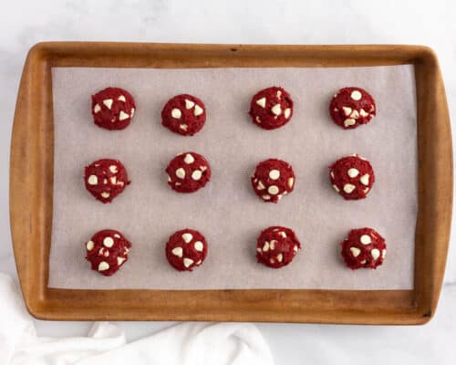 red velvet cookie dough balls on pan