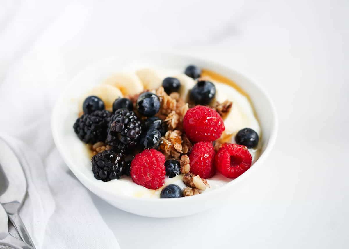 Building the perfect yogurt bowl is way more fun than you might think! Load it up or keep it simple, and enjoy a cool creamy bowl of yogurt with just the right combination of flavors and textures for breakfast or snack! yogurt bowl with berries in bowl