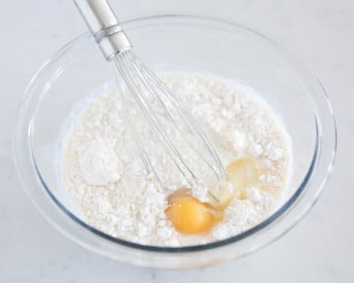 flour and egg in glass bowl
