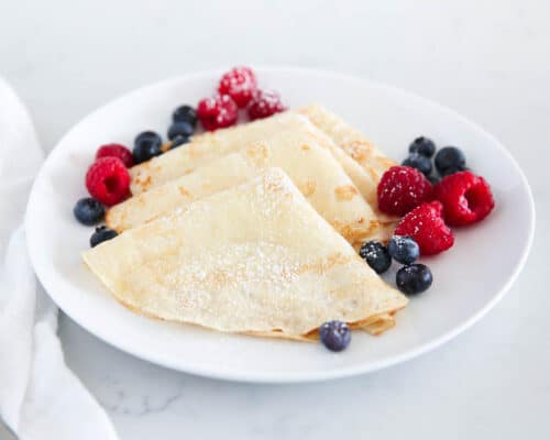 folded crepes on white plate