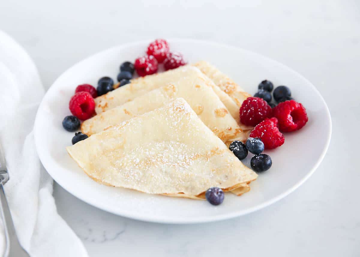 folded crepes on white plate