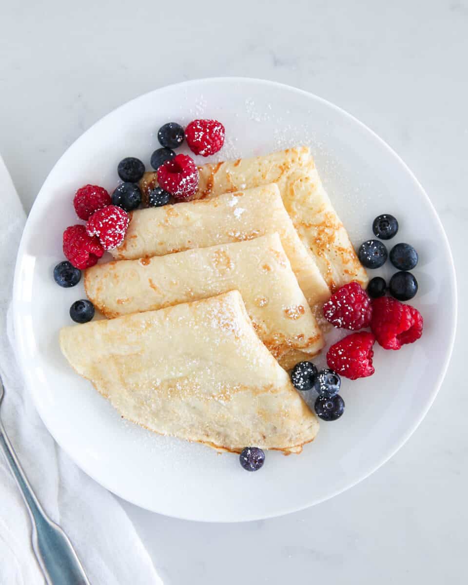 folded crepes on white plate