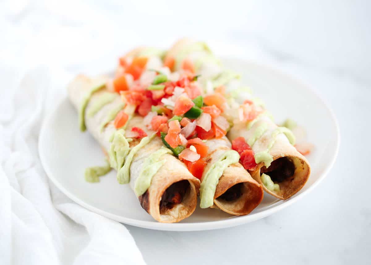 black bean taquitos on white plate