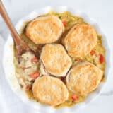 spoon of biscuits on top of chicken pot pie