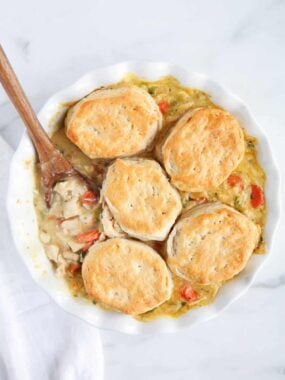 spoon of biscuits on top of chicken pot pie