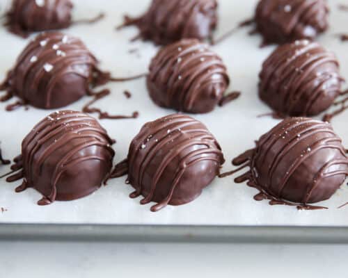 chocolate peanut butter balls on baking sheet