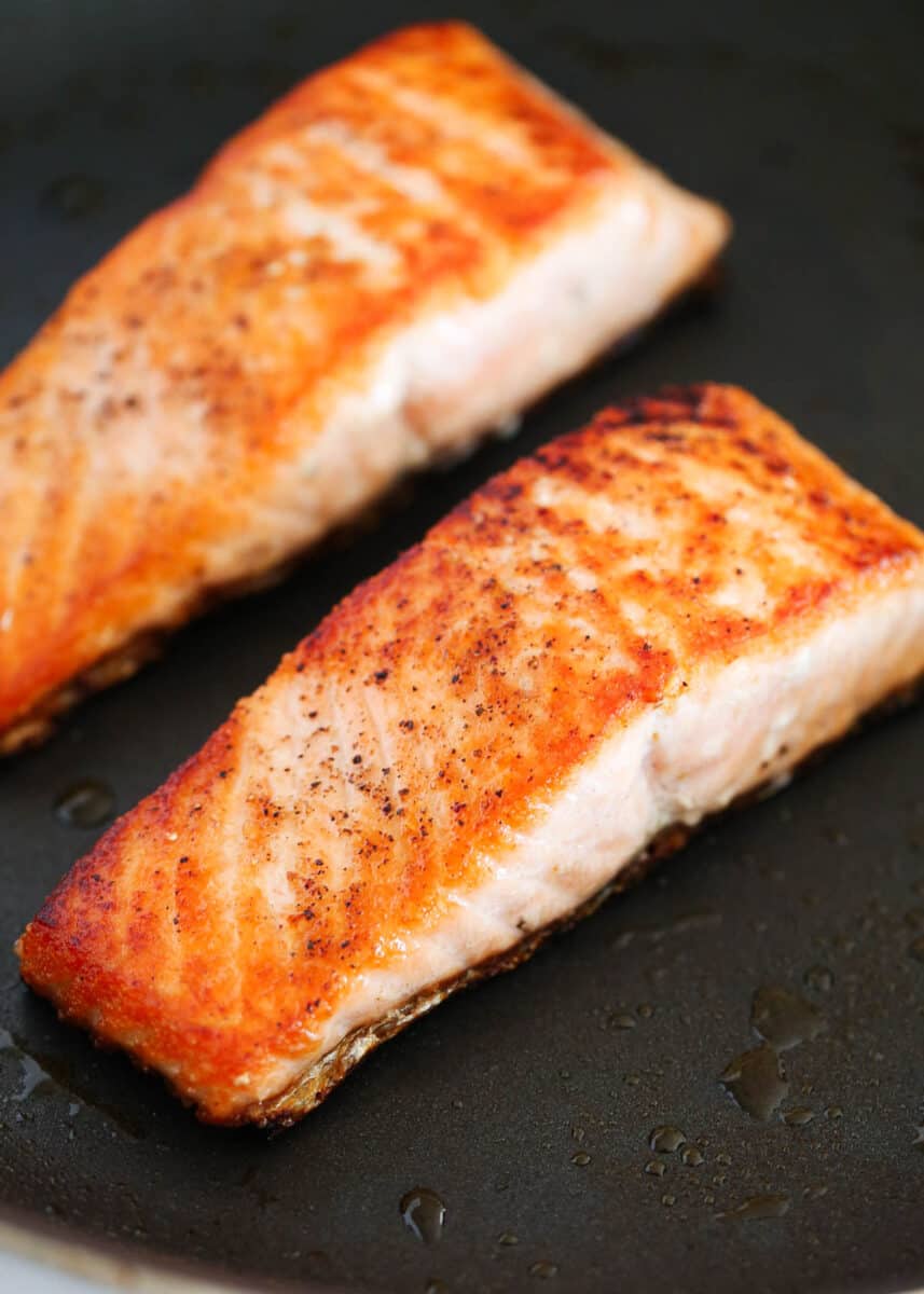 salmon cooking in skillet