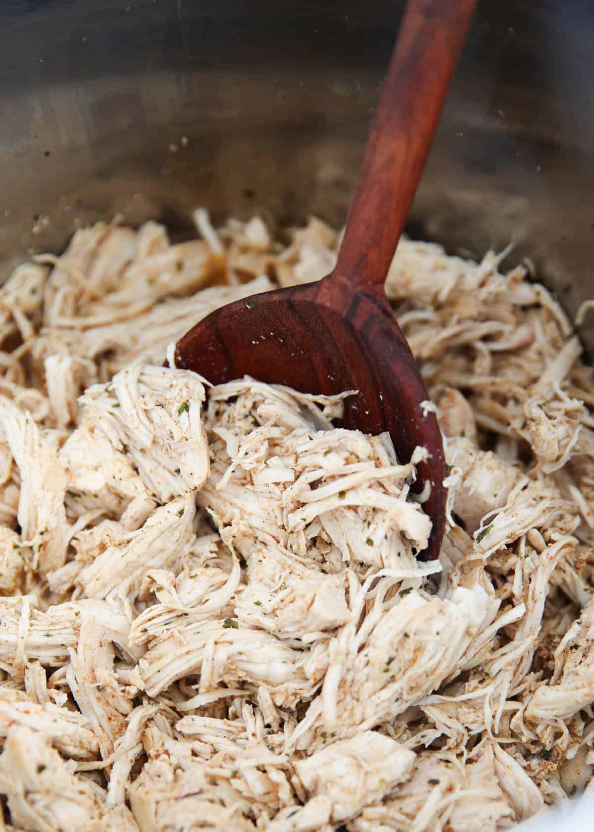 shredded chicken in pot with spoon