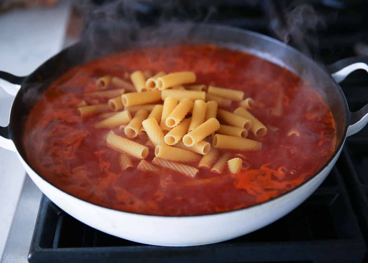 sauce and noodles cooking in pot