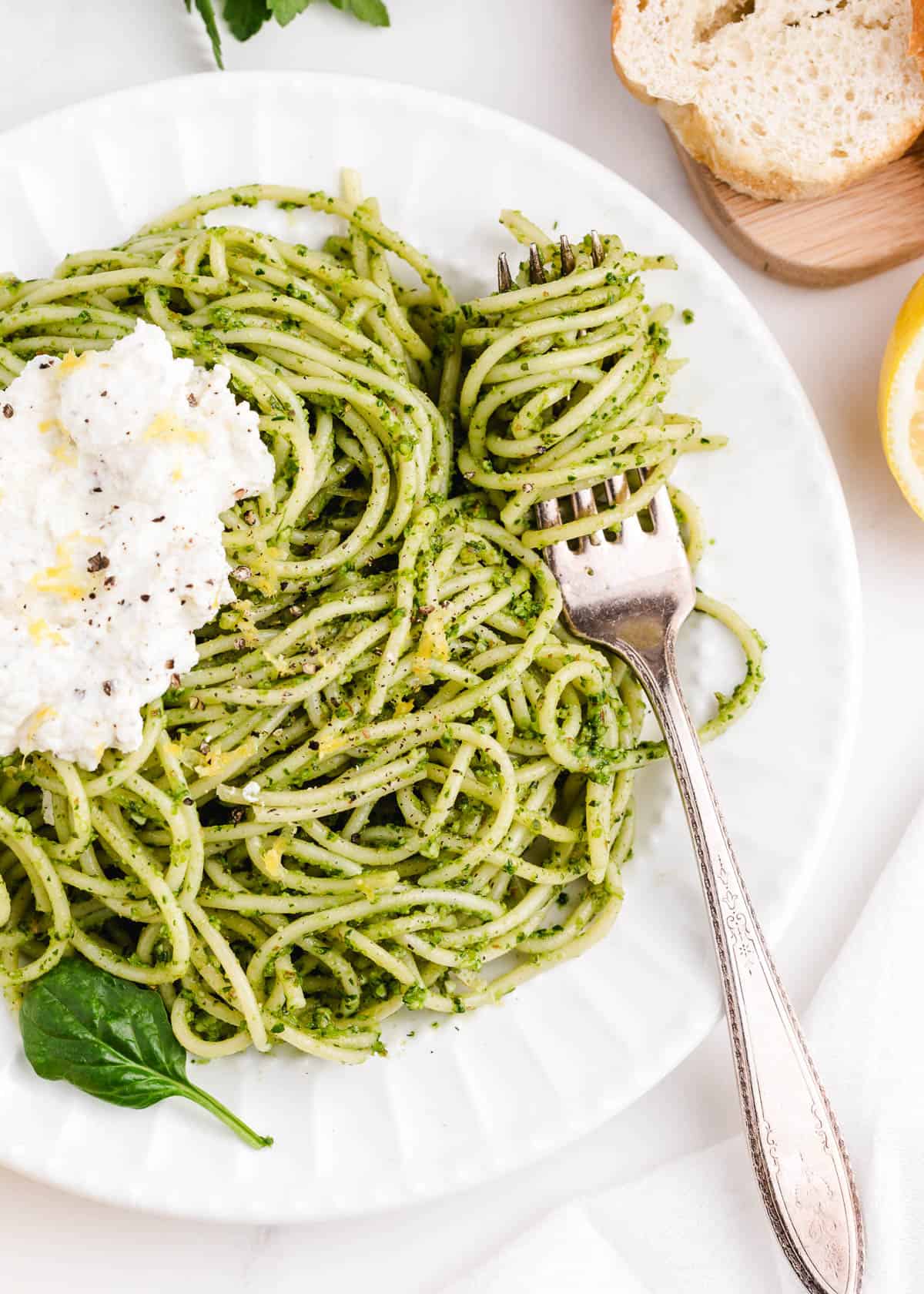 spaghetti pesto with fork on plate