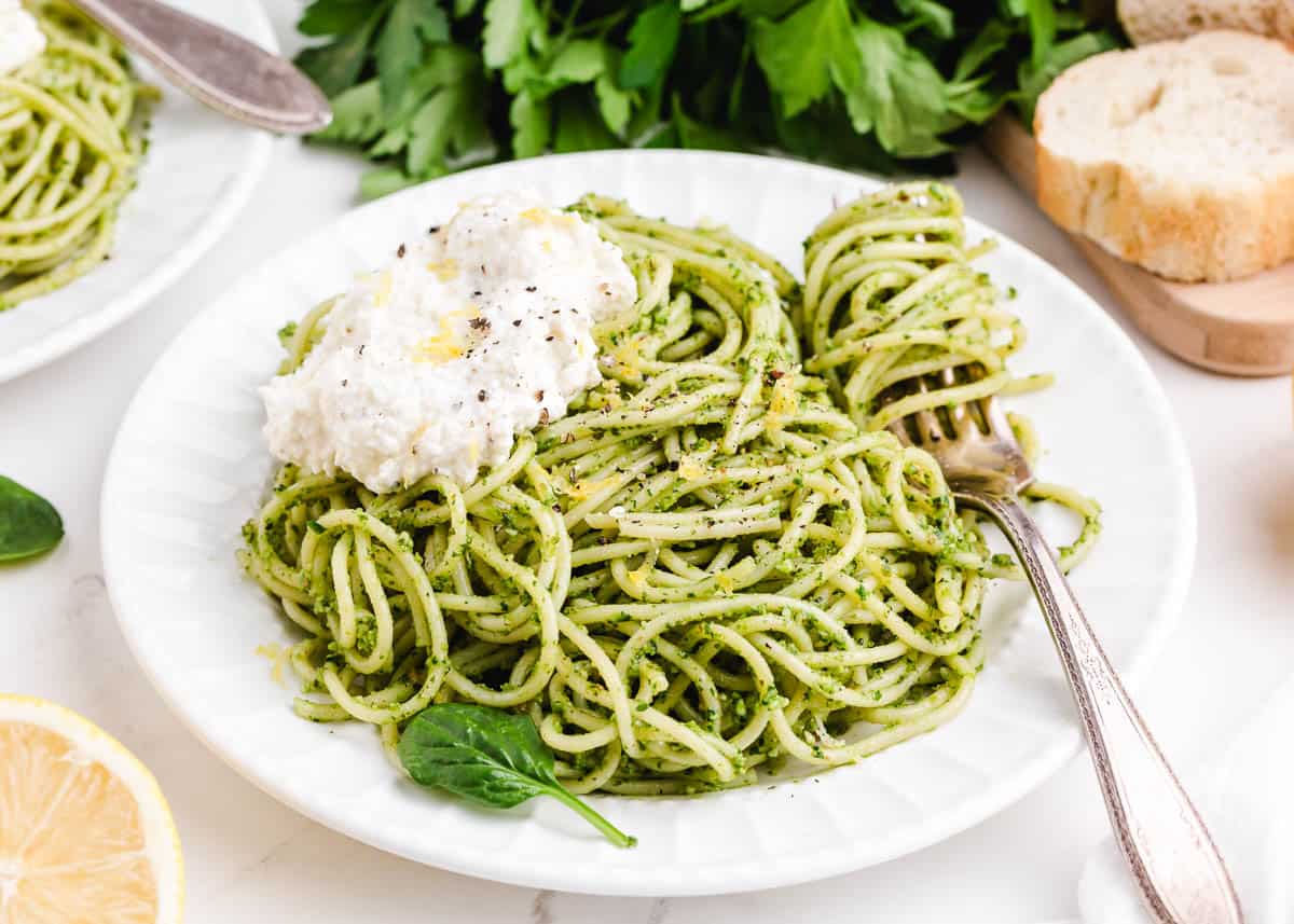 spaghetti pesto with fork on white plate