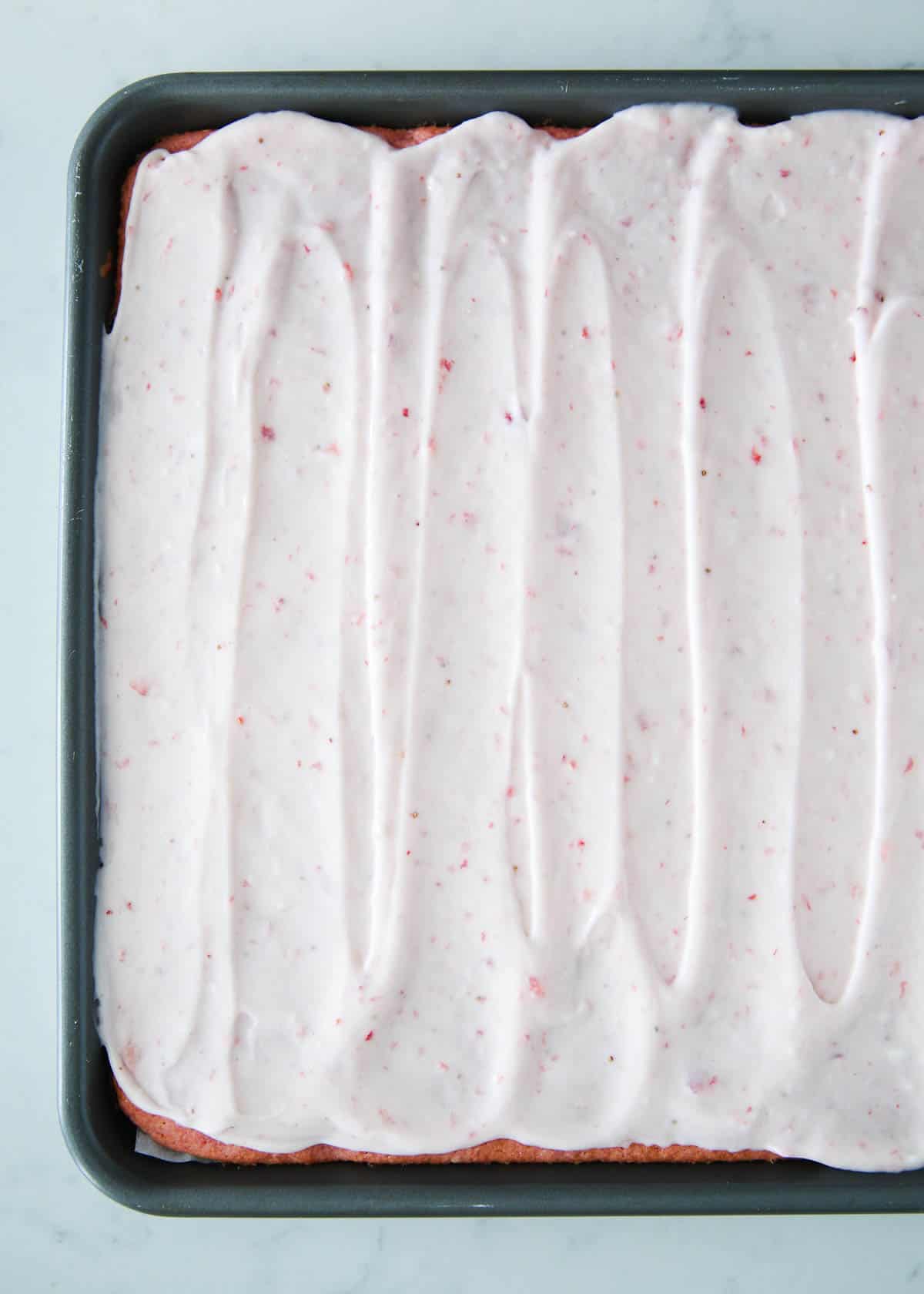 strawberry cream cheese frosting on top of cake