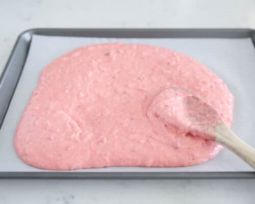 spreading strawberry cake in pan