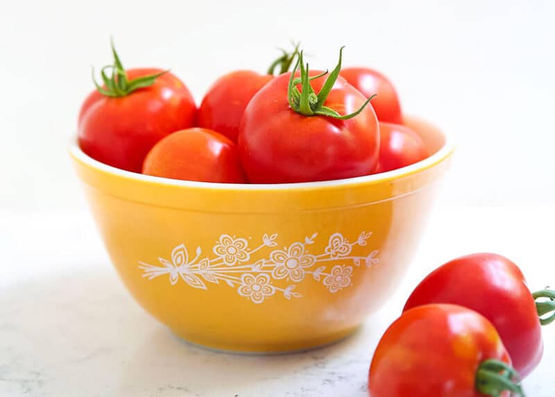 Tomatoes in yellow bowl.