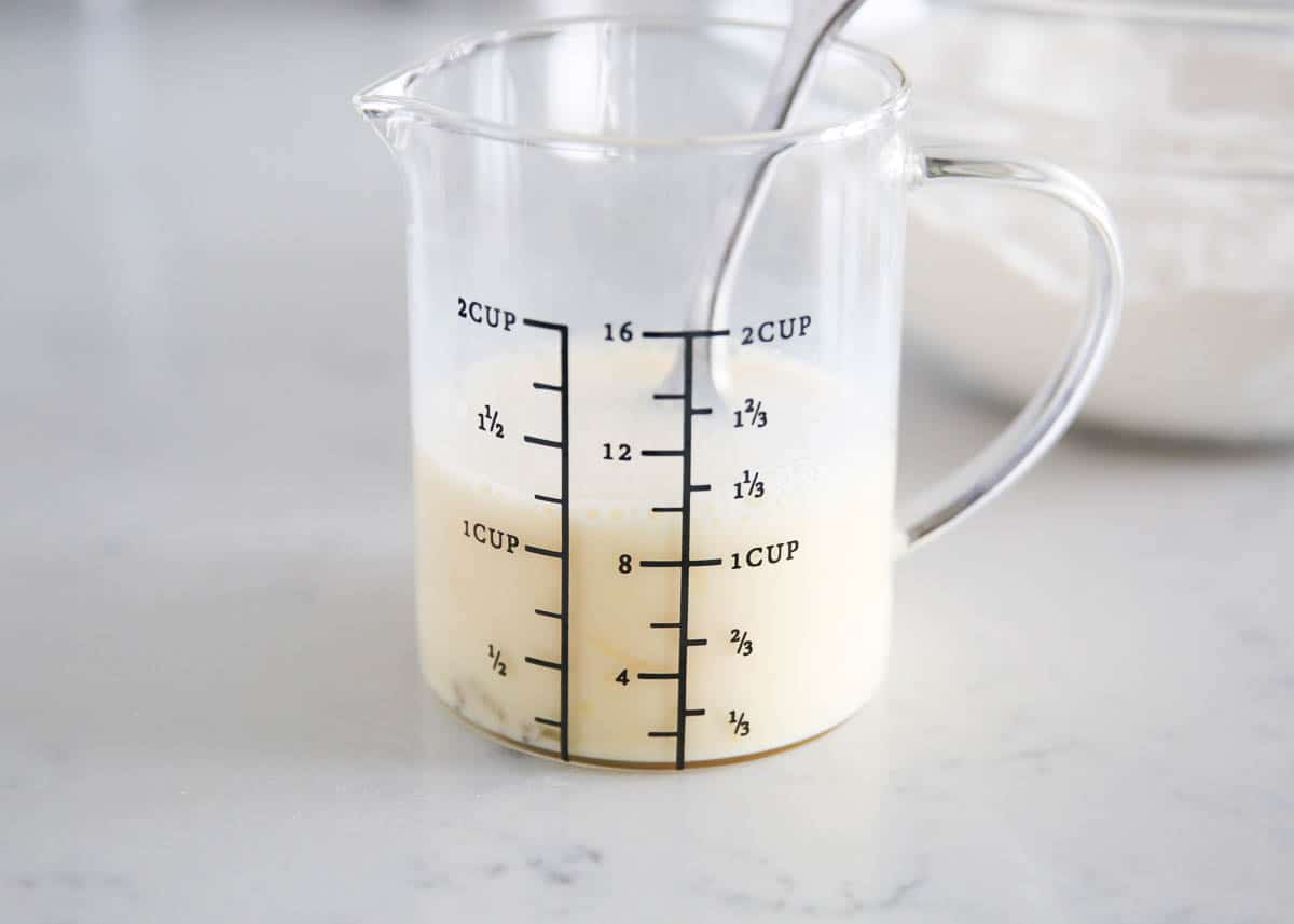 whisking milk in measuring cup