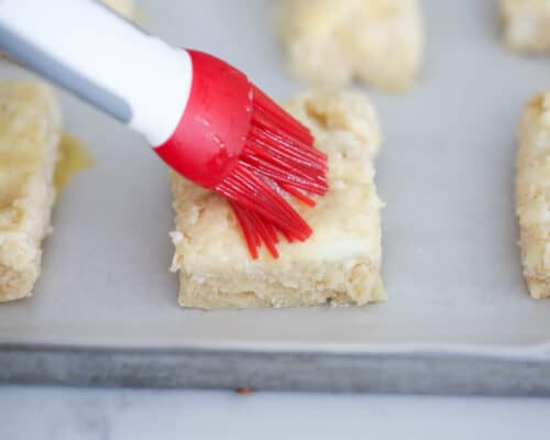 brushing egg white on top of scones