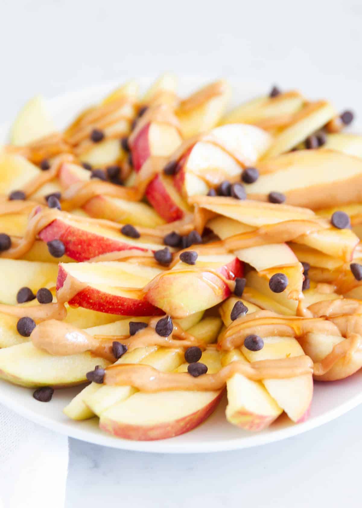 sliced apple nachos with peanut butter on top