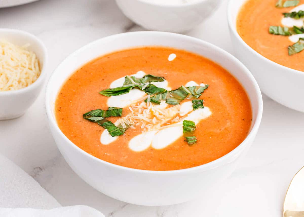 cauliflower tomato soup in white bowl