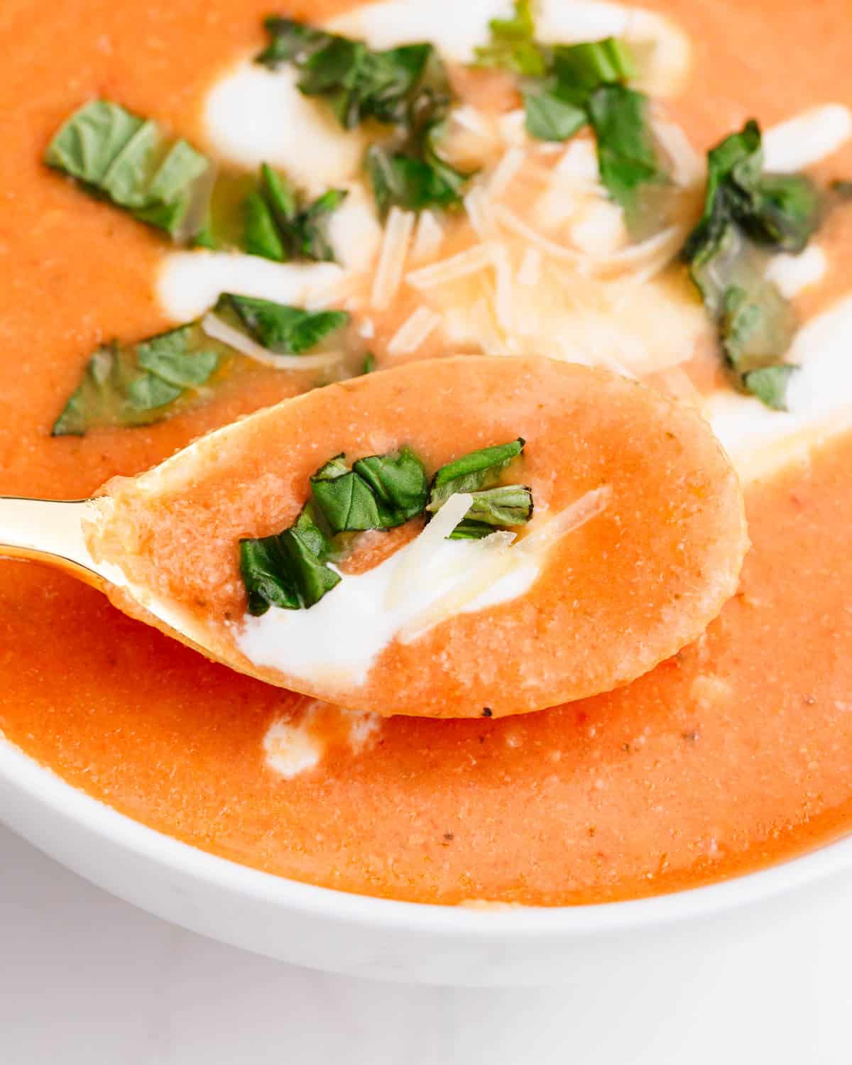 Close up of a spoonful of cauliflower tomato soup.