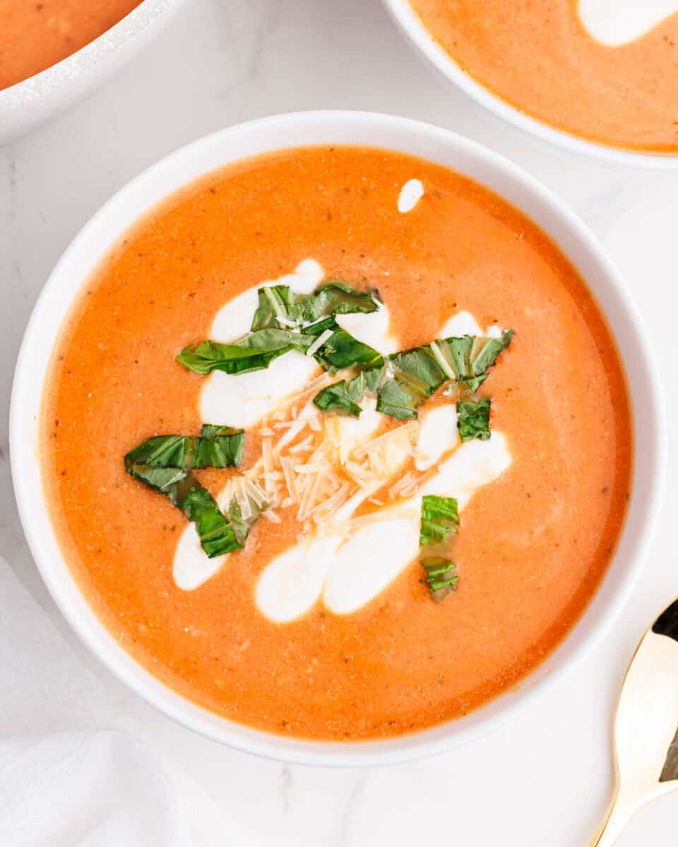 This easy cauliflower tomato soup is thick, creamy and full of flavor. The perfect healthy soup recipe that's comforting and delicious! cauliflower tomato soup in white bowl