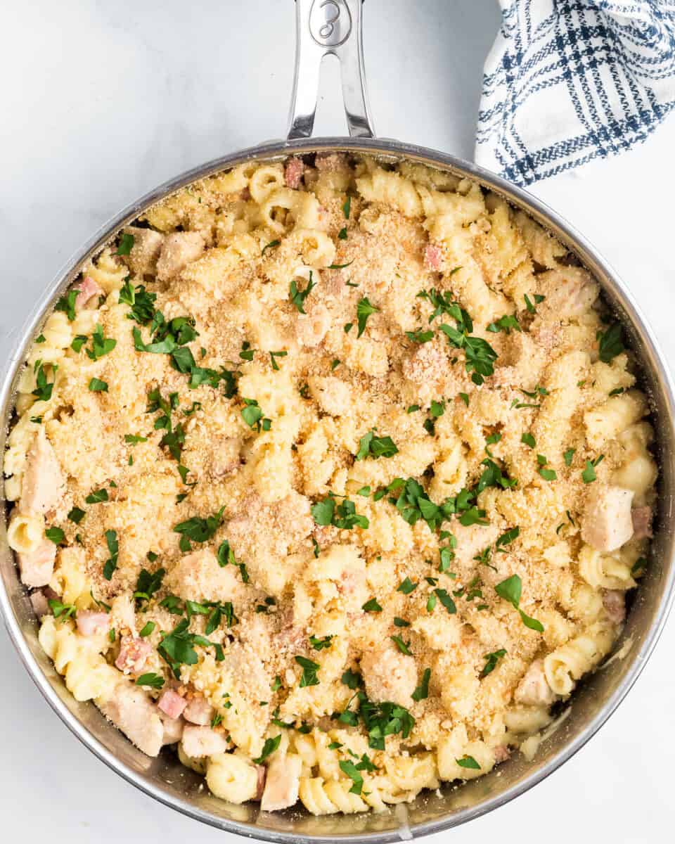 chicken cordon bleu pasta in pan with parlsey