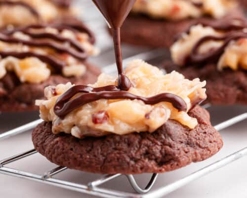 drizzling chocolate over top of german chocolate cookie