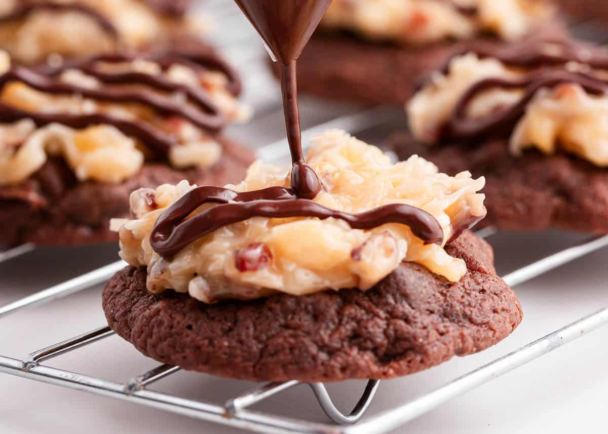 drizzling chocolate over top of german chocolate cookie