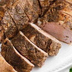 sliced pork tenderloin on white plate
