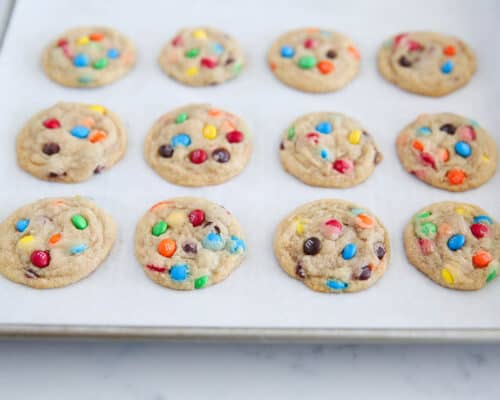 mini m&m cookies on baking sheet