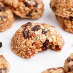 Oatmeal raisin cookies with a bite missing to show soft and tender texture.