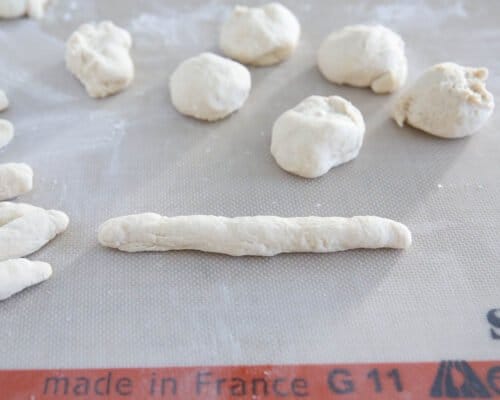 rolling dough onto baking mat