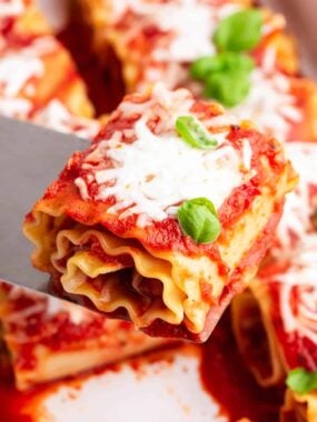 pepperoni lasagna roll up being scooped out of pan