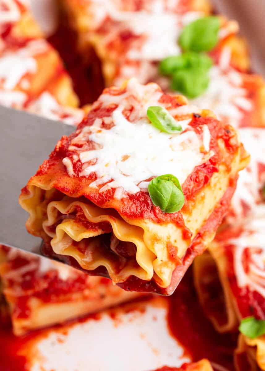 pepperoni lasagna roll up being scooped out of pan