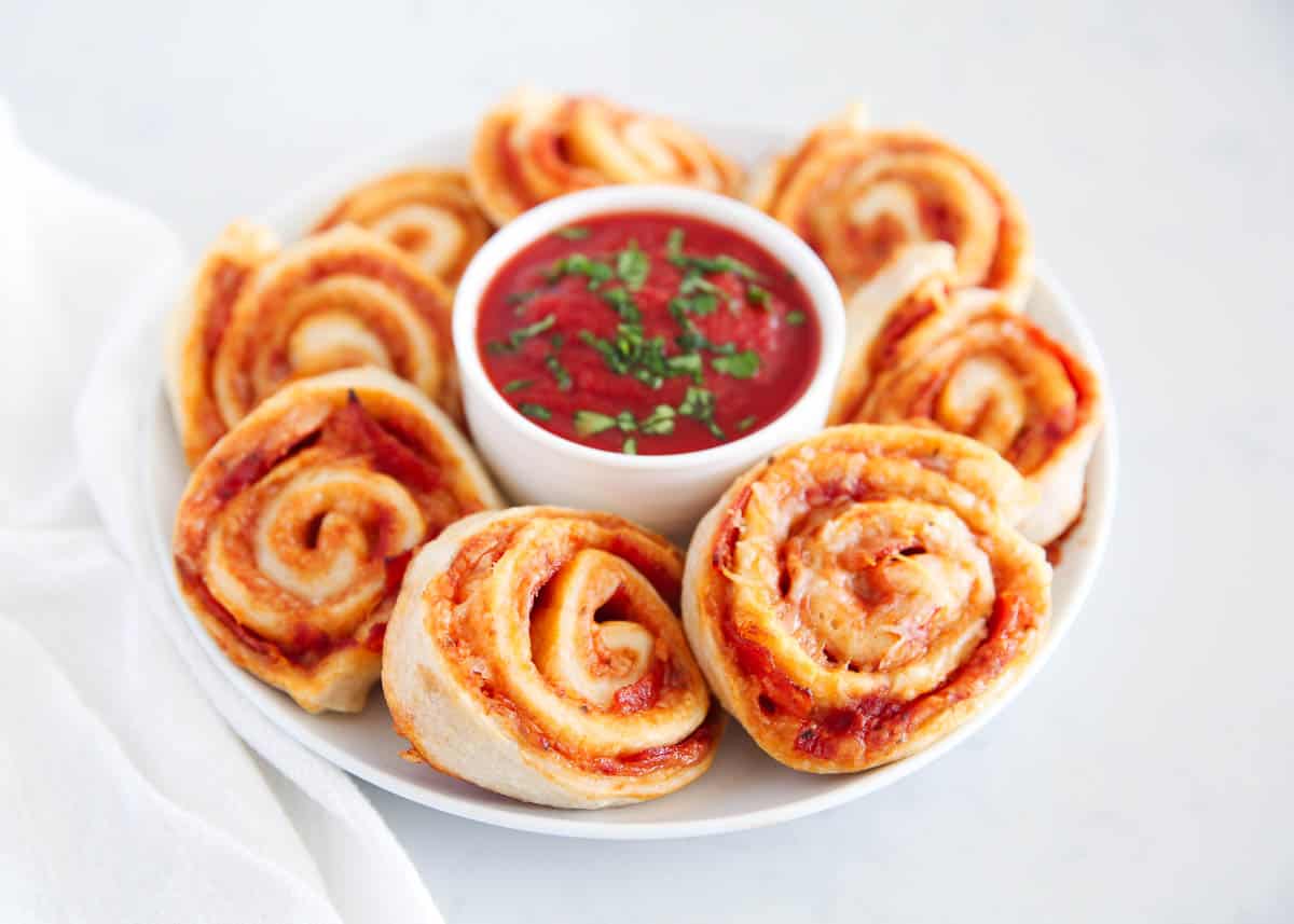 pizza pinwheels on white plate