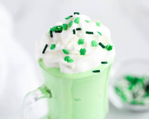 green shake with sprinkles and whipped cream on top